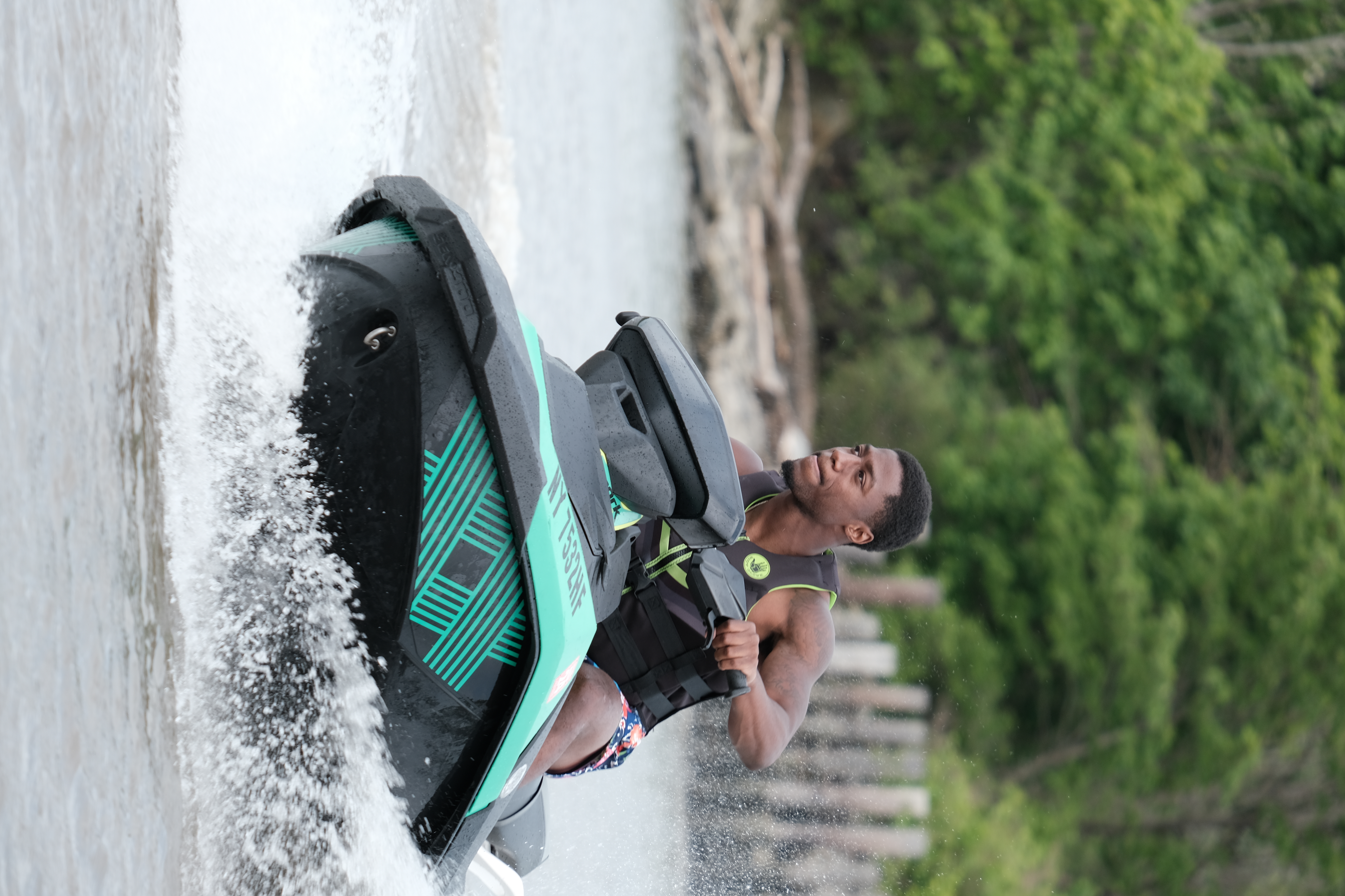 Jet ski rider making a sharp turn with water spray on the Hudson River — Hudson Valley water sports, adrenaline activities near NYC